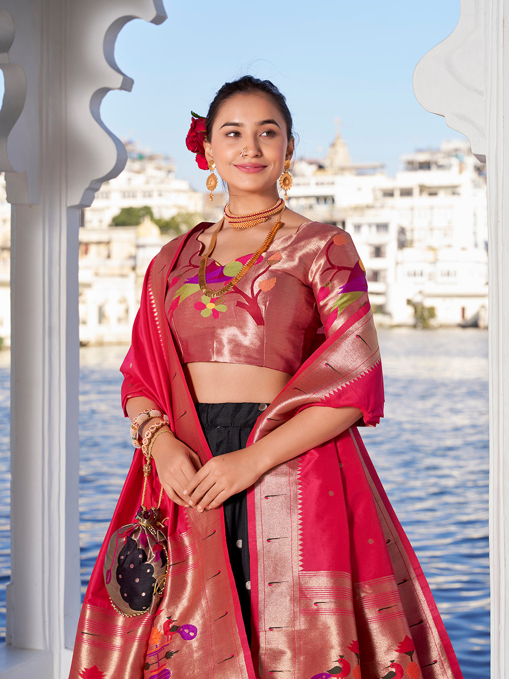 Elegant black jacquard silk lehenga choli with zari weaving matching potli purse